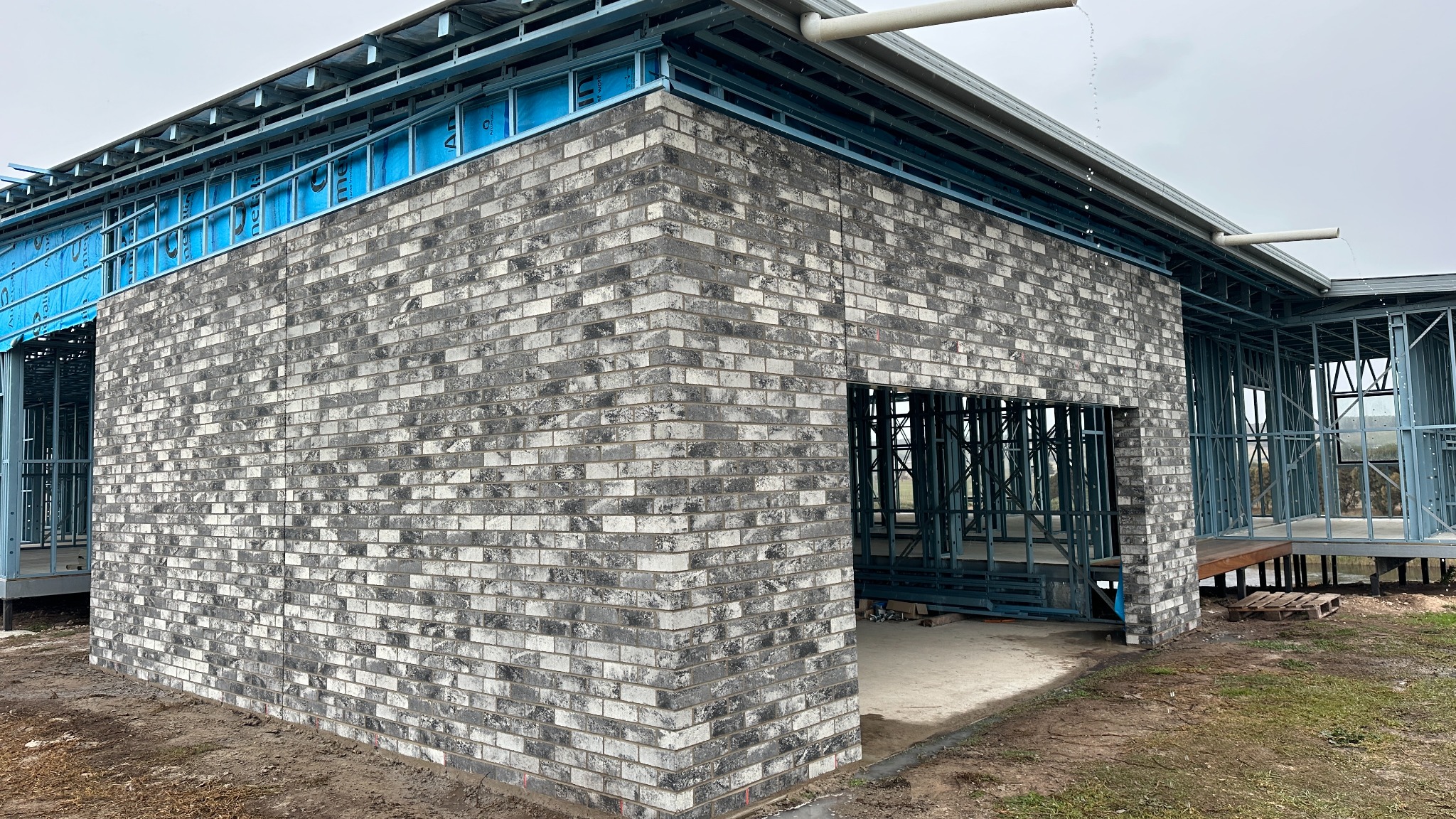 Grey feature brick home under construction