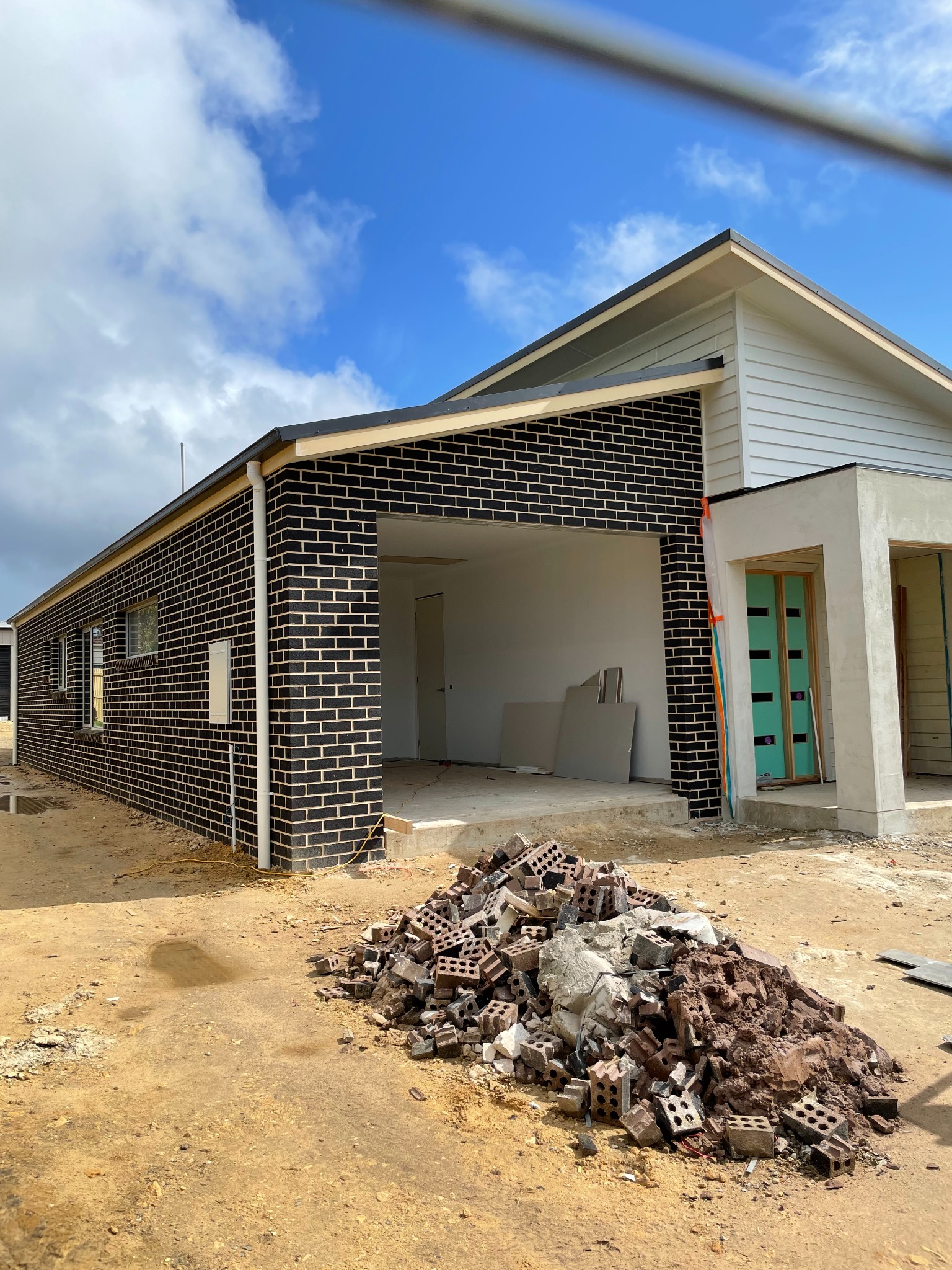 Dark brick residence under construction